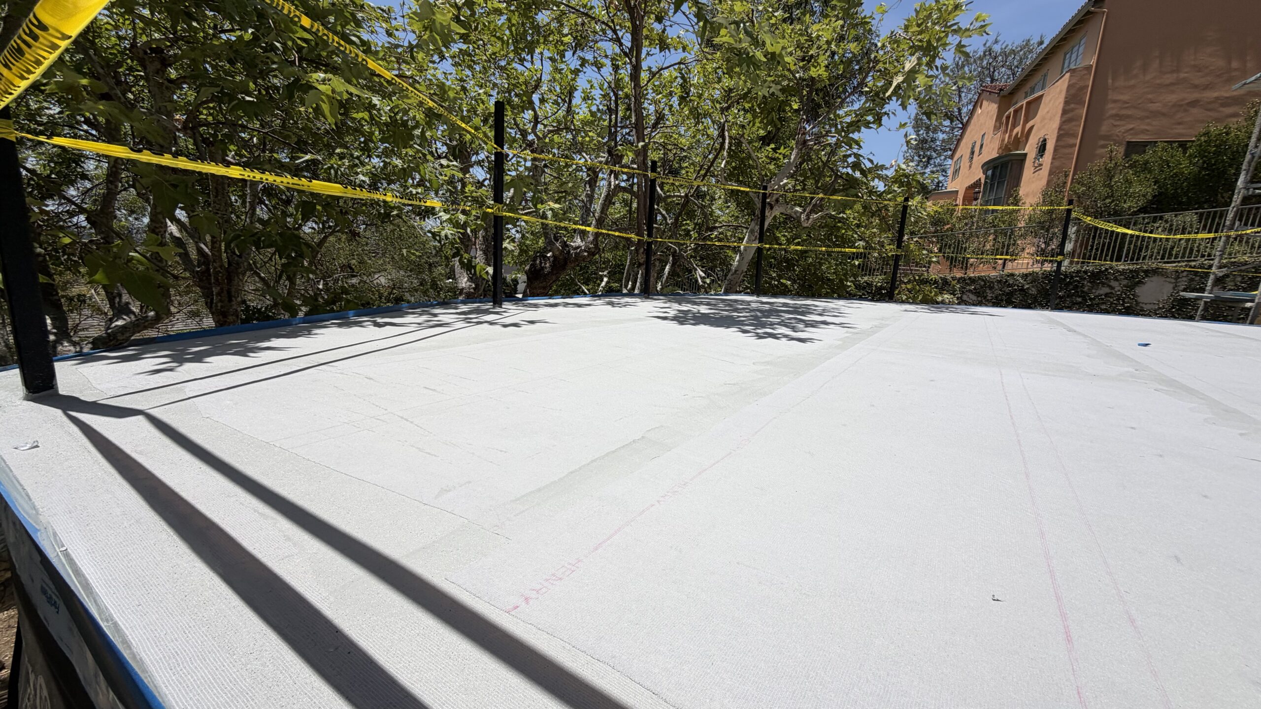 Wide view of fully sealed square balcony deck with high parapet walls